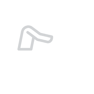 Icon of a person sitting at a desk using a laptop computer.